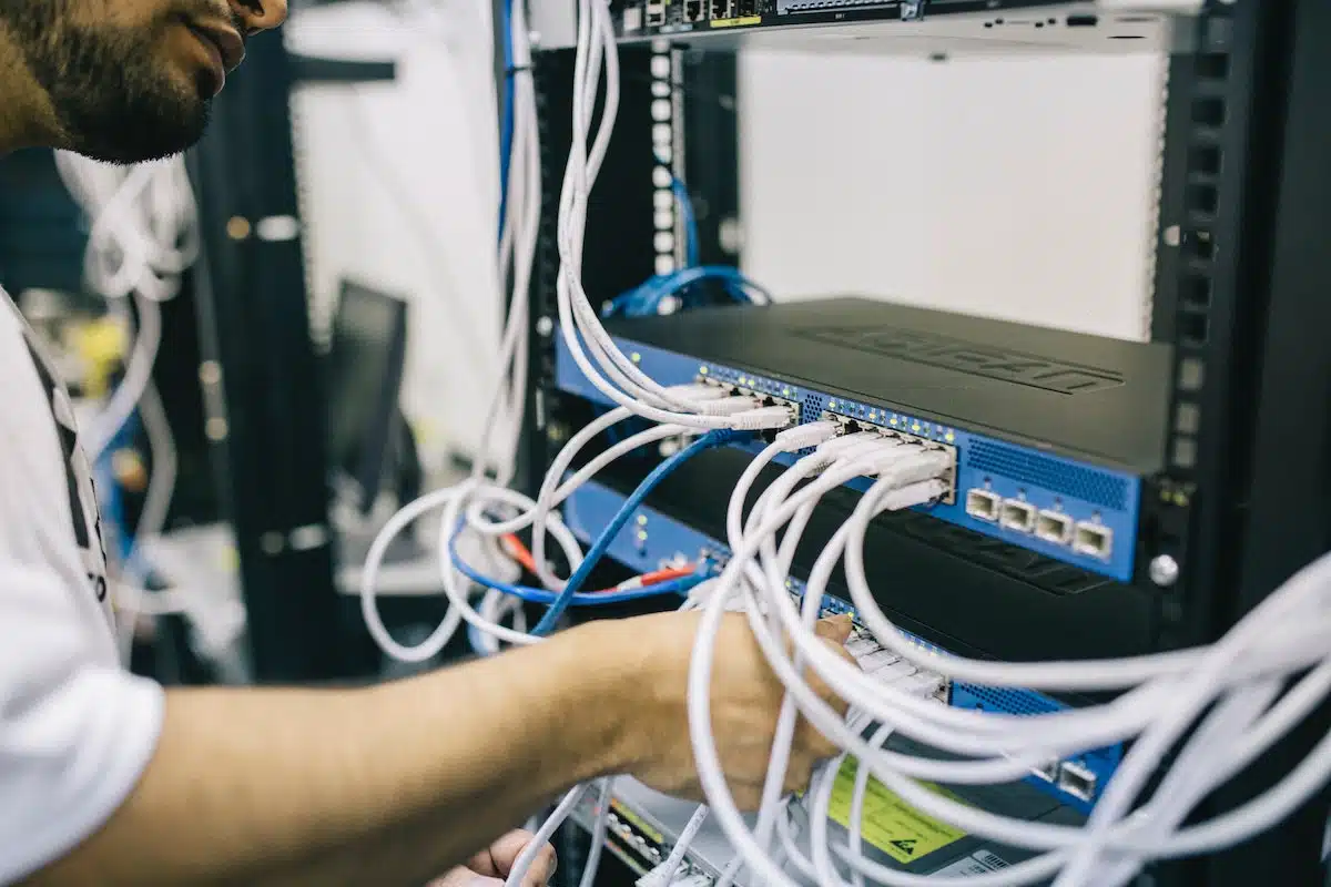 A man connecting a computer to a server